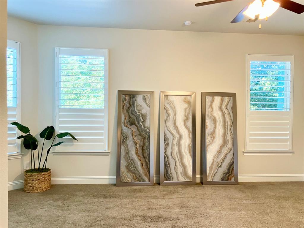 Partial view of the main bedroom suite downstairs, custom extra-wide shutters