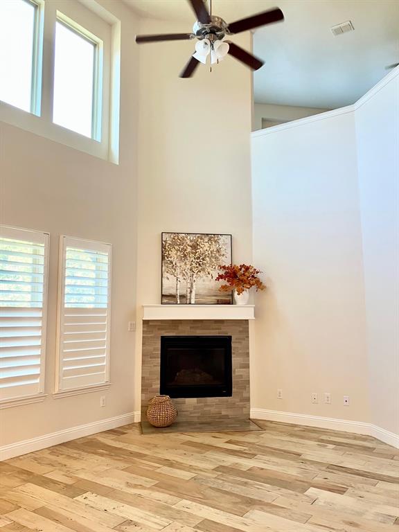 Soaring ceiling, tasteful new paint, sanded wood flooring, rich custom shutters