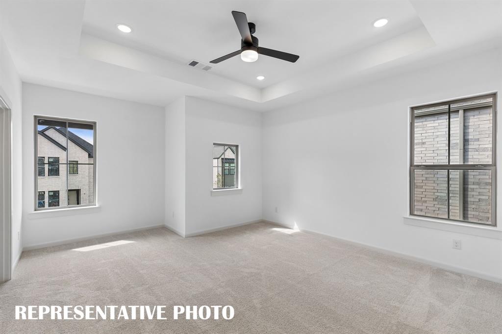 High ceilings, plush carpeting and plenty of natrual light, this owner's bedroom was designed for rest and relaxation.  REPRESENTATIVE PHOTO