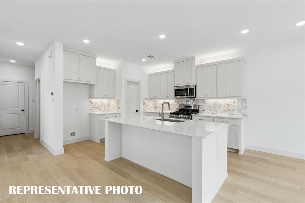 Featuring plenty of storage and prep space, all the chefs in the family will love this dream kitchen!  REPRESENTATIVE PHOTO
