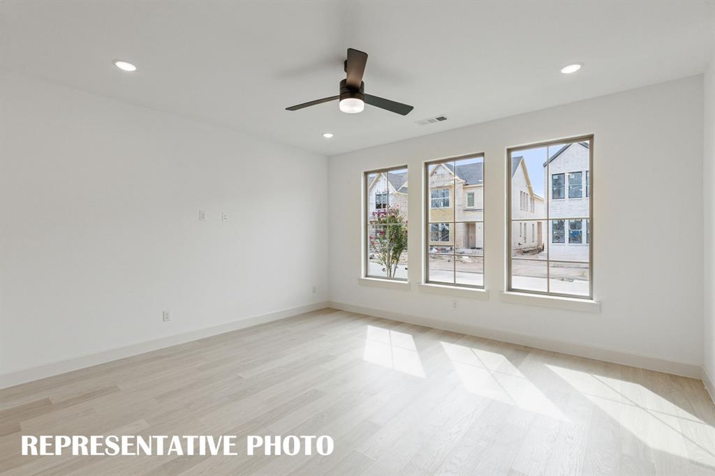 Your new family room if flooded with natural light from a wall of windows.  REPRESENTATIVE PHOTO