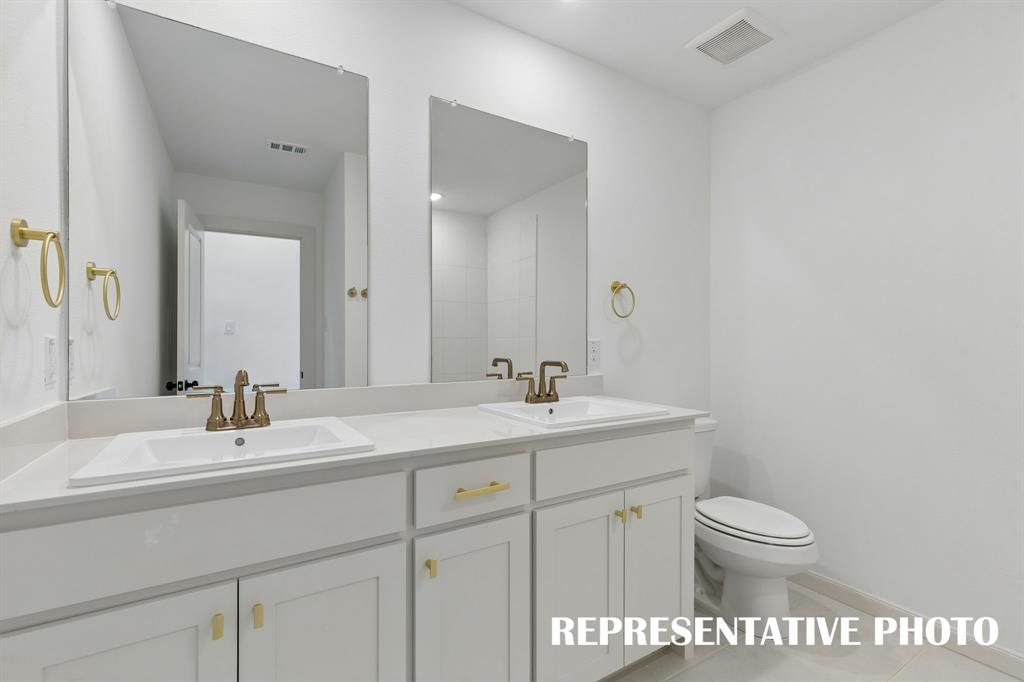 Guests will enjoy their own vanity space in this thoughtfully designed guest bath.  REPRESENTATIVE PHOTO