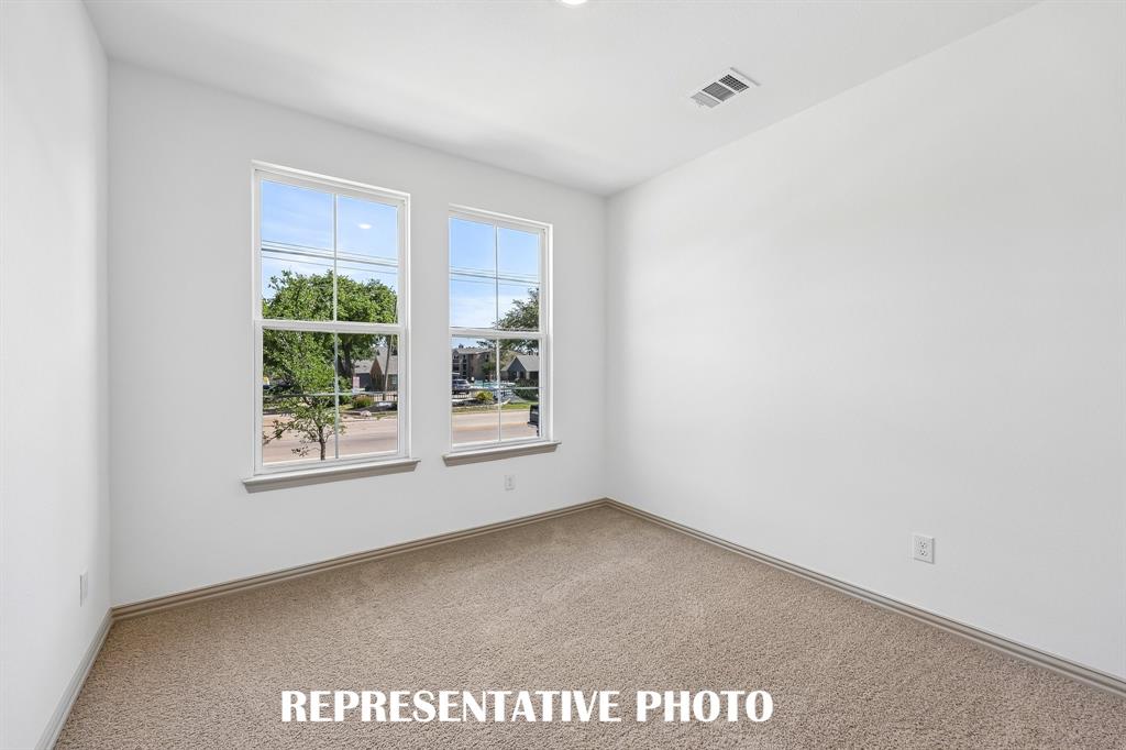 You'll find a nicely sized secondary bedroom on the main floor in our Harper plan.  REPRESENTATIVE PHOTO