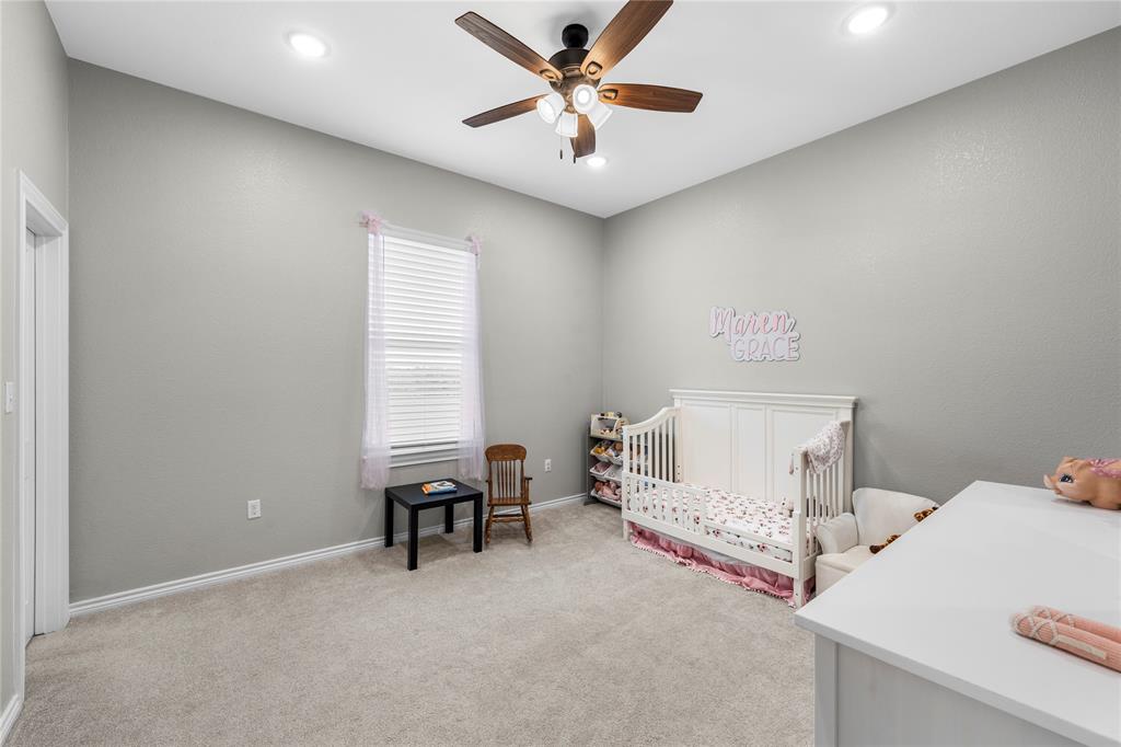 Neutral interior room featuring neutral carpeting, high ceilings, recessed lighting, and a ceiling fan with integrated light fixture