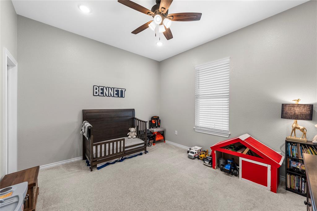Neutral-toned room featuring high ceilings, neutral wall-to-wall carpeting, a multi-blade ceiling fan with integrated lighting, and a window with horizontal blinds