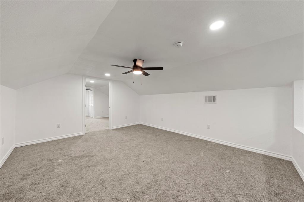 Sloped ceilings with recessed lighting, integrated ceiling fan, and wall-to-wall carpeting