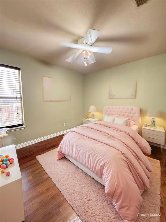 Wood-finish flooring, white multi-blade ceiling fan with integrated lighting, and horizontal window blinds