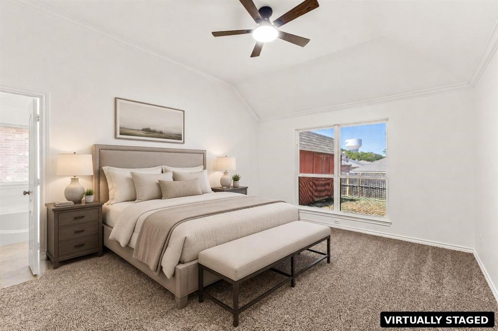 Vaulted ceiling, ceiling fan with integrated lighting, neutral wall-to-wall carpeting, and large paneled windows