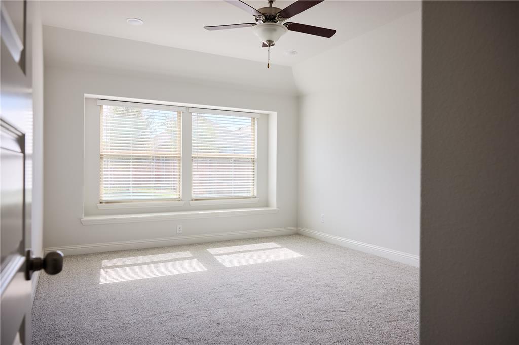 Neutral interior featuring a tray ceiling, wall-to-wall carpeting, recessed lighting, and a ceiling fan with integrated lighting