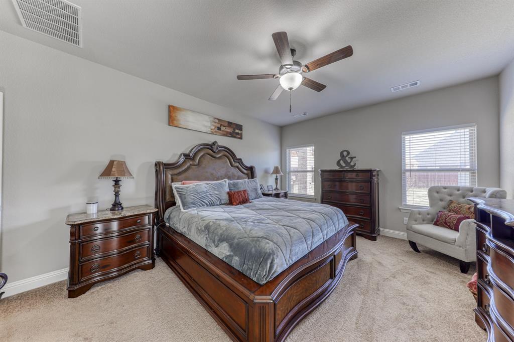 Spacious room with neutral wall coloring, ceiling fan with integrated lighting, wall-to-wall carpeting, and dual windows with horizontal blinds