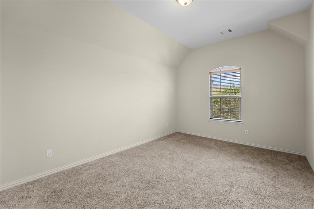 Interior space featuring high vaulted ceilings, wall-to-wall carpeting, and an arched window with horizontal blinds