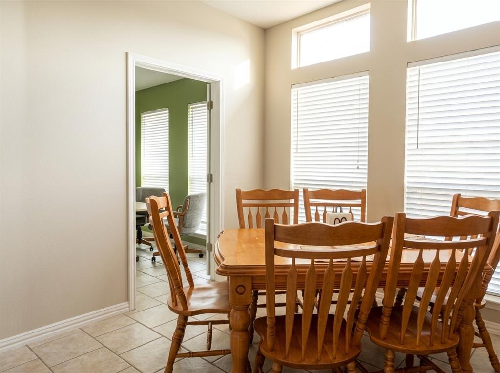 Tiled flooring, high ceilings with transom windows, and neutral wall tones