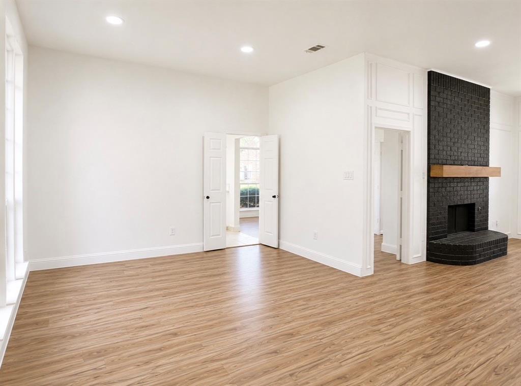 Interior space featuring wood-finish flooring, recessed lighting, and floor-to-ceiling wainscoting
