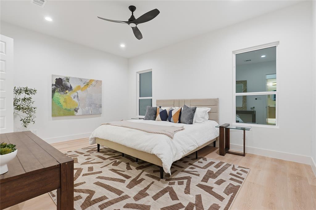Spacious interior featuring wood-finish flooring, recessed lighting, and a modern ceiling fan with a matte black finish