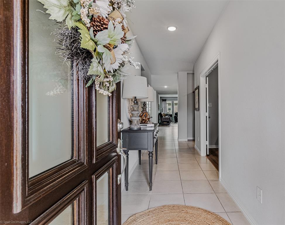 Corridor featuring light tile patterned floors and recessed lighting Corridor featuring light tile patterned floors and recessed lighting