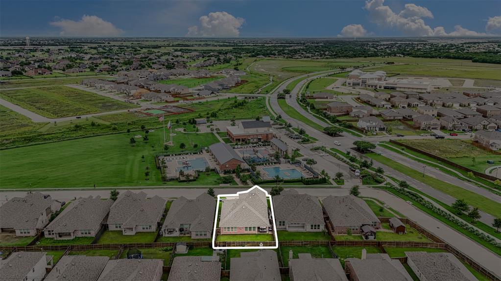 Aerial view of residential area featuring property boundaries highlighted and a pool