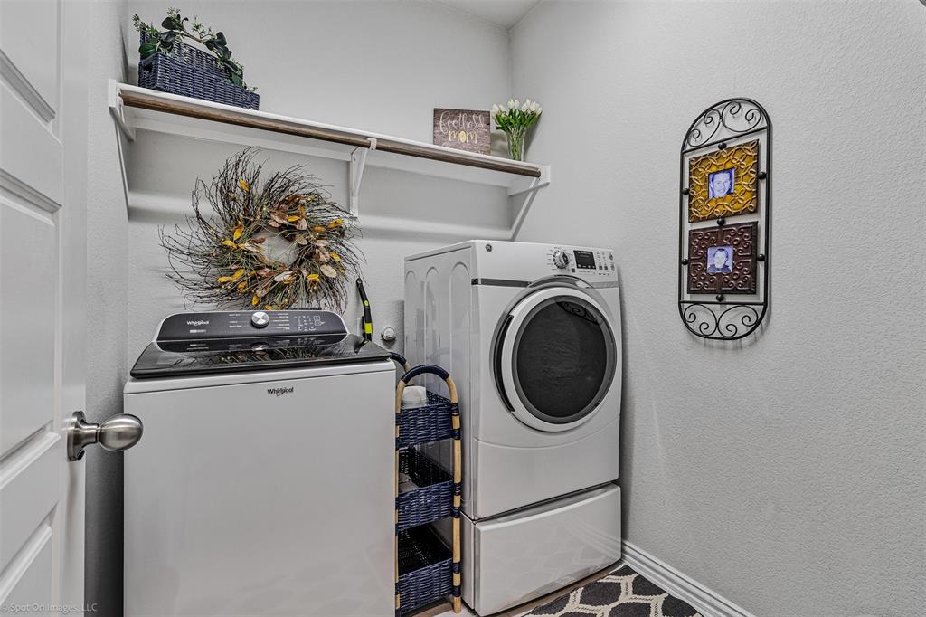 Washroom with washer and clothes dryer