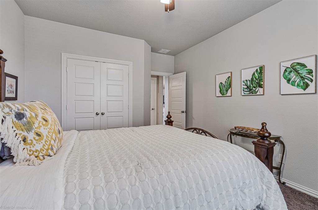 Carpeted bedroom featuring a closet and a ceiling fan