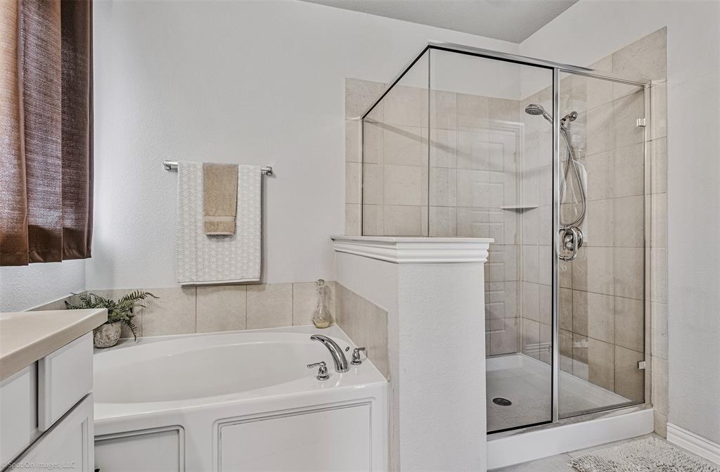 Full bathroom with a bath, a shower stall, and vanity