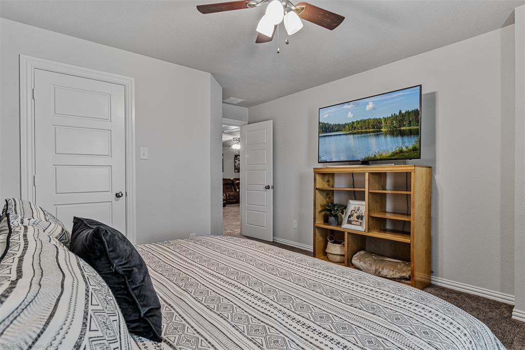 Bedroom with carpet flooring and ceiling fan