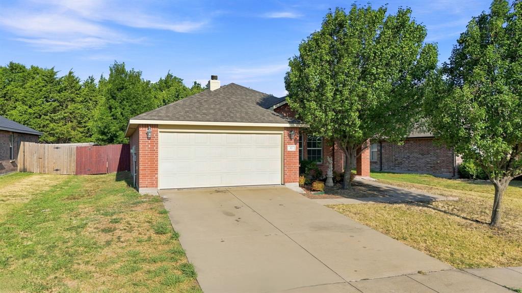 Single-story residence featuring a brick exterior, a two-car garage, and a concrete driveway