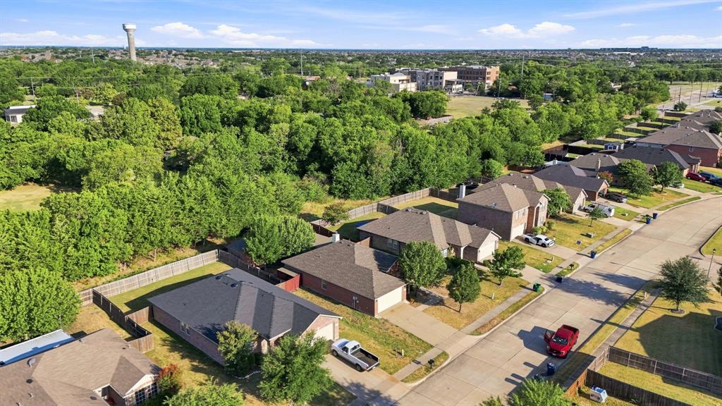 Aerial perspective featuring brick exteriors, multi-hip rooflines, and paved residential streets