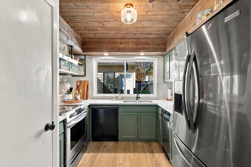 Kitchen featuring wood-paneled ceiling, custom sage green cabinetry, stainless steel appliances, quartz countertops, and wood-finish flooring