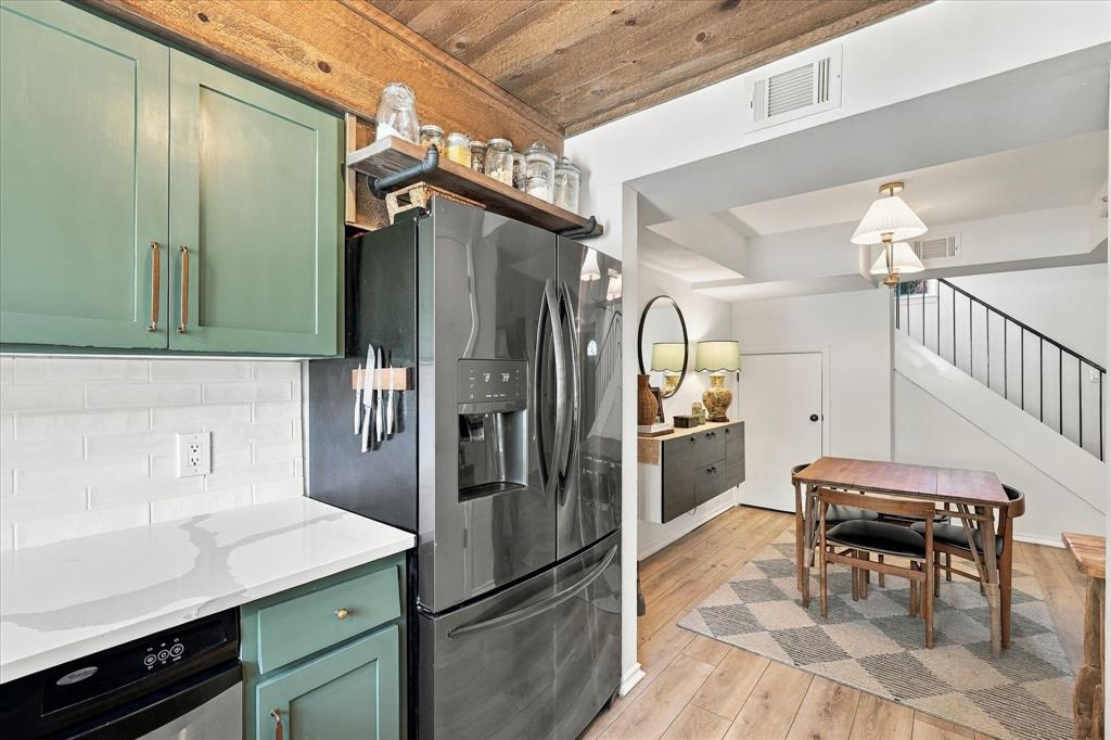 Kitchen featuring painted shaker-style cabinetry, white quartz countertops, subway tile backsplash, and a tongue-and-groove wood plank ceiling