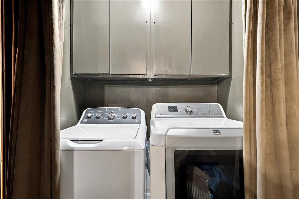 Laundry nook featuring built-in overhead cabinetry