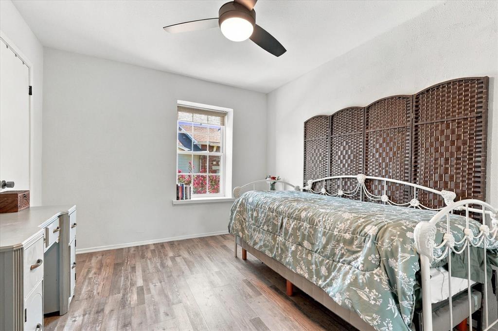Wood-finish flooring, multi-pane window, and ceiling fan with integrated lighting