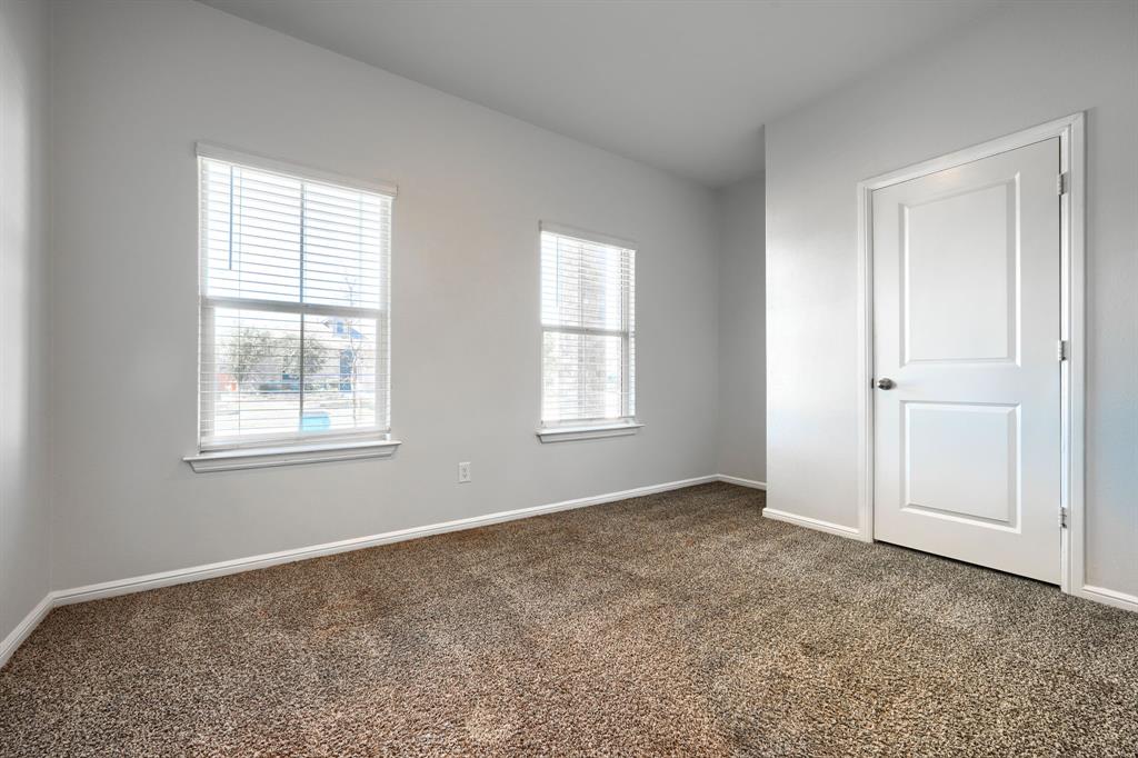 Neutral wall tones, wall-to-wall carpeting, two dual-pane windows with integrated blinds, and a solid-core interior door