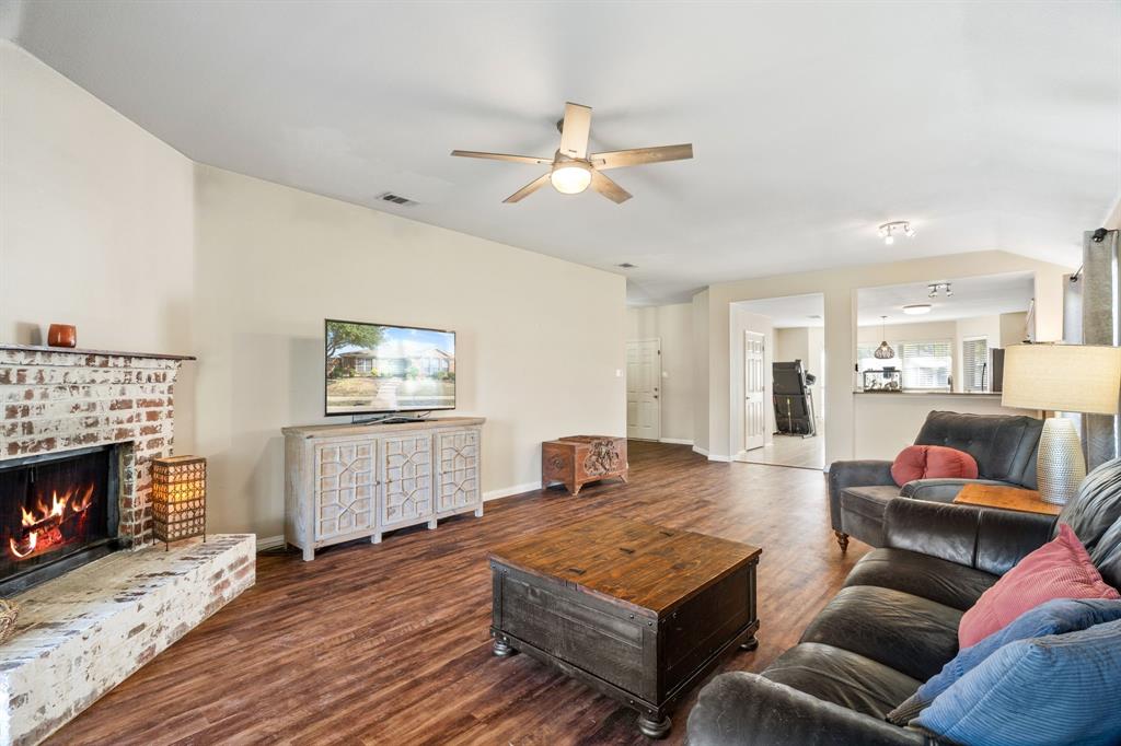 The expansive family room features a gorgeous gas fireplace. and a ceiling fan complete with remote.