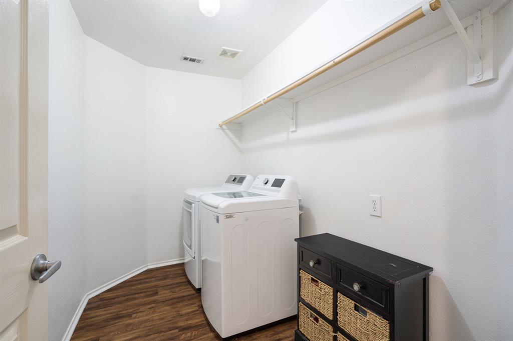 The freshly painted laundry room includes the washer and dryer