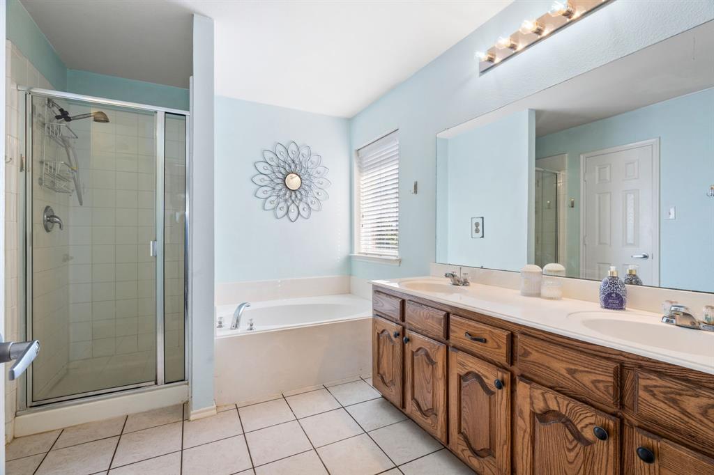 The primary suite includes an ensuite bath with double sinks, a relaxing soaking tub, a separate shower, and a large walk in closet.