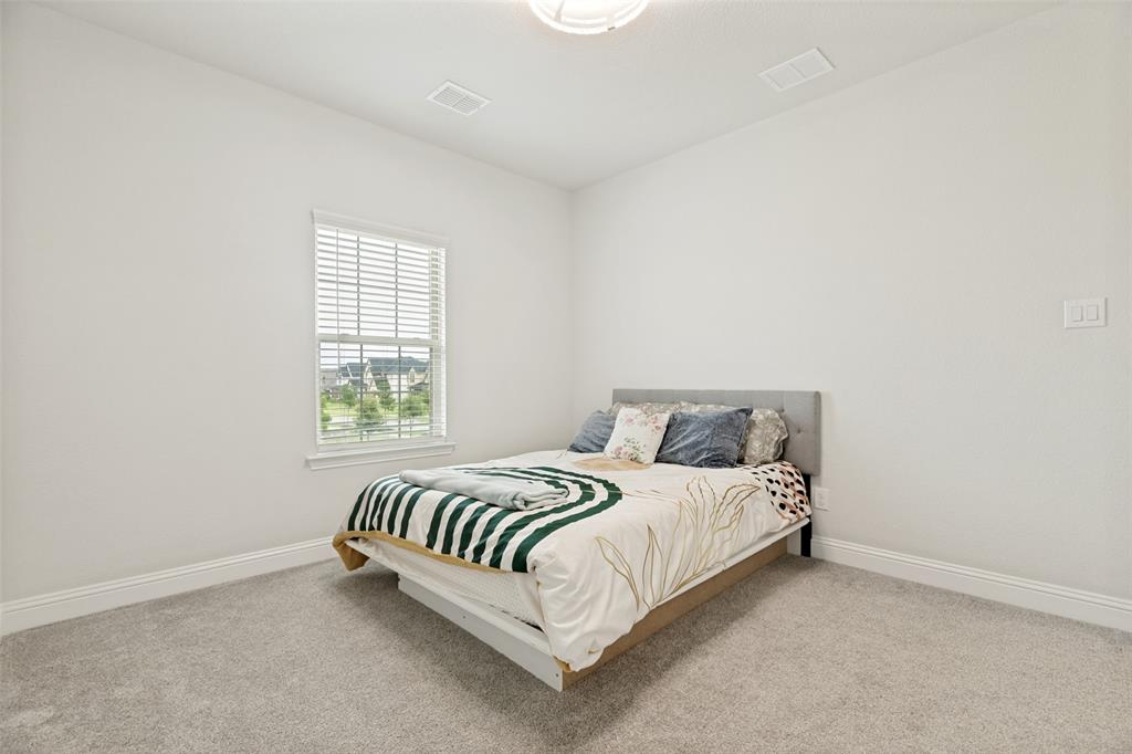 Neutral-toned wall finish, high ceilings, carpeting, and a single-pane window with interior blinds