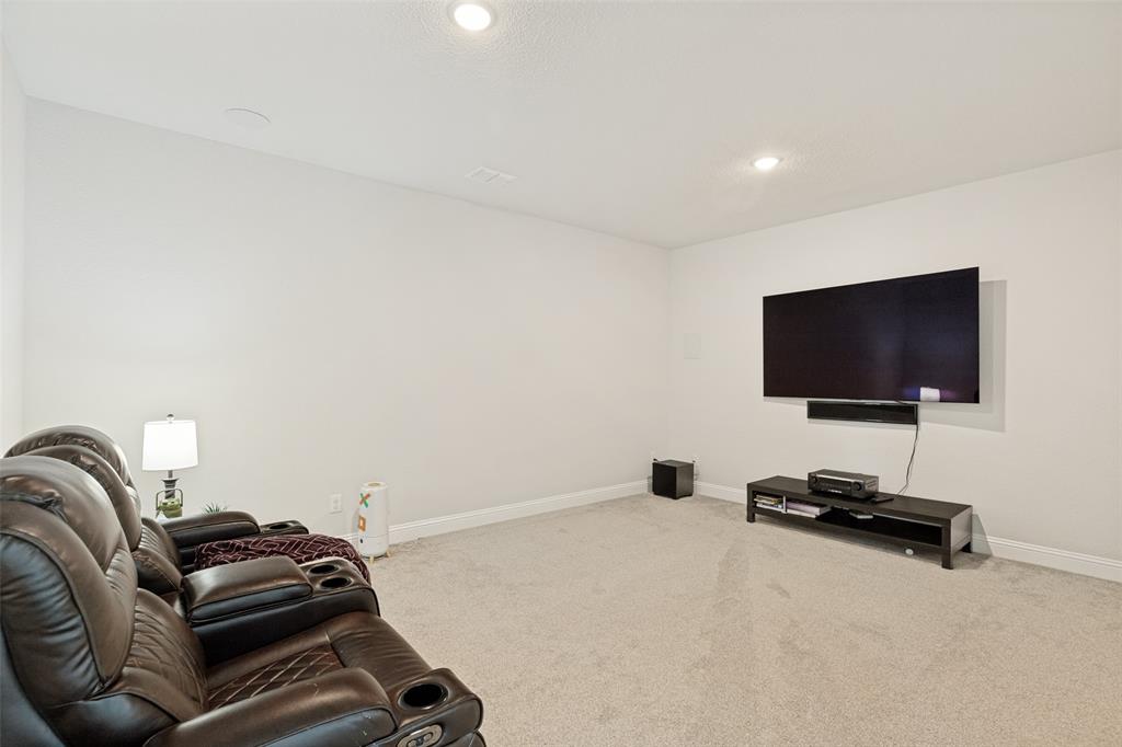 Neutral-toned room featuring wall-to-wall carpeting and recessed ceiling lighting