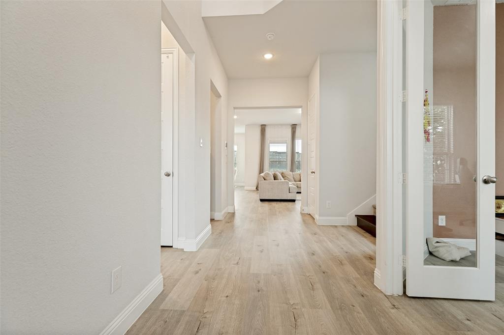 Foyer featuring wood-finish flooring, recessed lighting, and a glass-panel French door