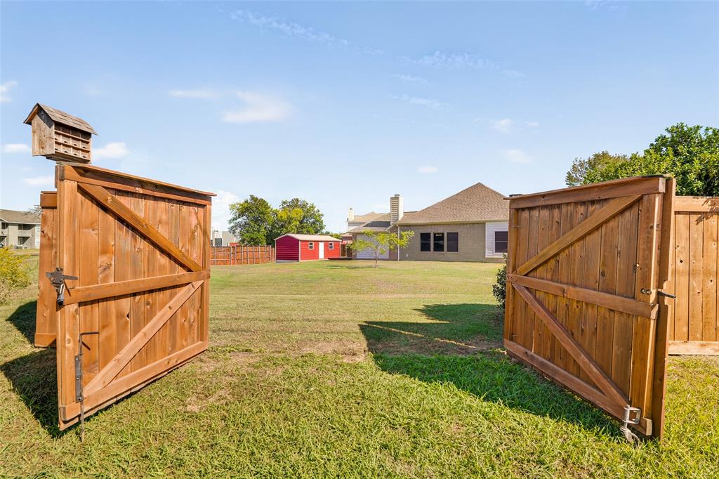 Expansive backyard featuring a rear double-gate entry, and the shop across this huge lot.