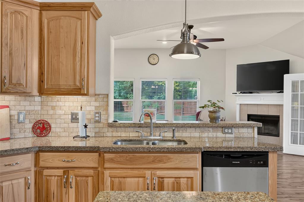 Kitchen sink with ss high-arc faucet looking into the living room and to the back yard.  Binge watch your fave show while washing dishes!