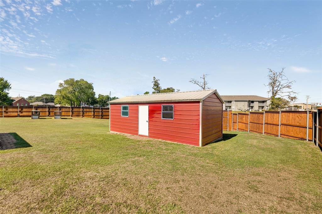 Detached workshop with metal siding, metal roof, and two windows.
