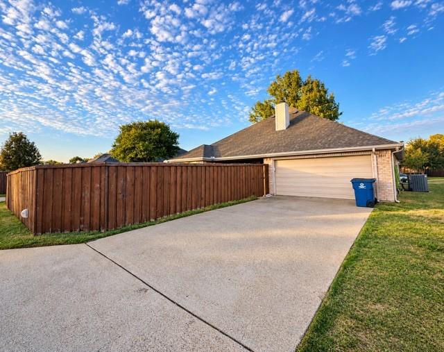 Driveway view gargage and fence with gate exterior security lights