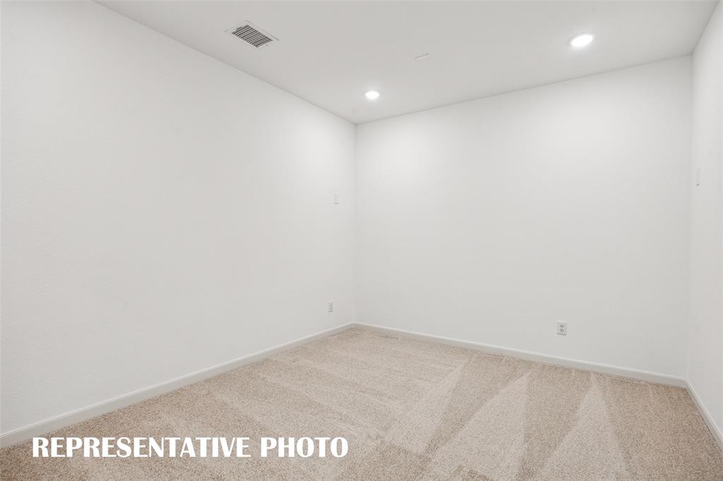 This spacious media room with adjacent game room create the ultimate family entertainment zone!  REPRESENTATIVE PHOTO