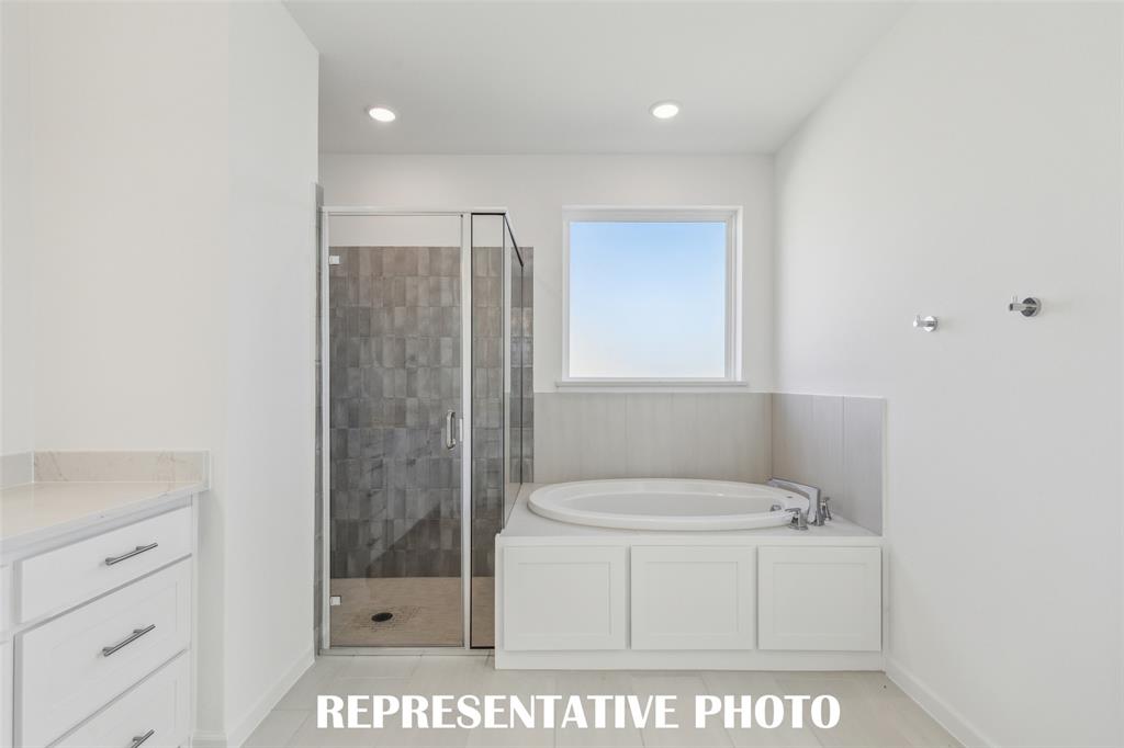 Whether it's soaking your cares away or indulging in a long, luxurious shower, this owner's bath has it all!  REPRESENTATIVE PHOTO
