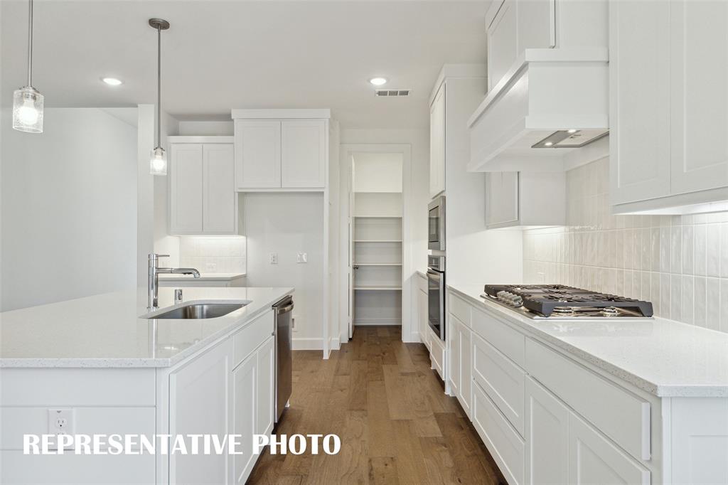 Site finished cabinetry, stainless appliances and gorgeous flooring combine to make this dream kitchen a reality!  REPRESENTATIVE PHOTO