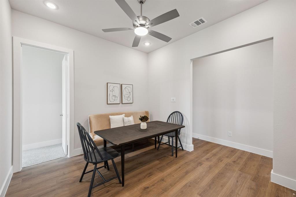 Wood-finish flooring, brushed nickel ceiling fan with integrated lighting, and recessed ceiling lights
