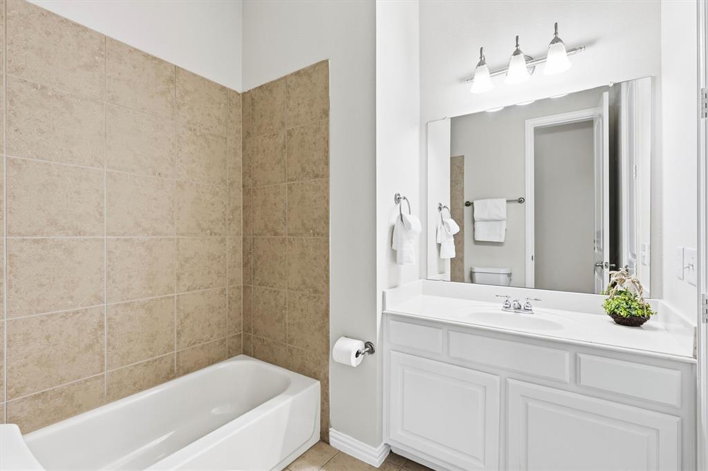 Downstairs full bath with access to both the office and downstairs secondary bedroom