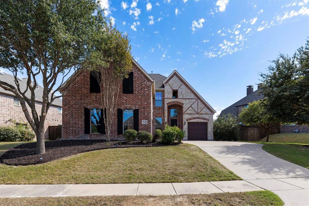 Mature trees, stained cedar shutters, brick and stone exterior. Perfect place to call home!