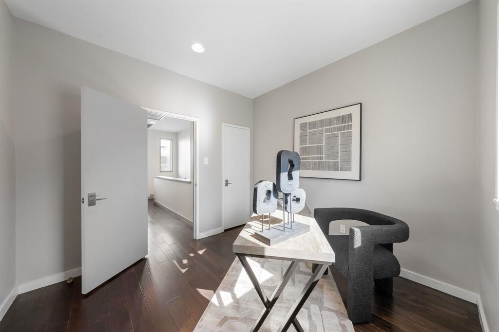 Interior space featuring wood-finish flooring, neutral wall paint, and recessed ceiling lighting
