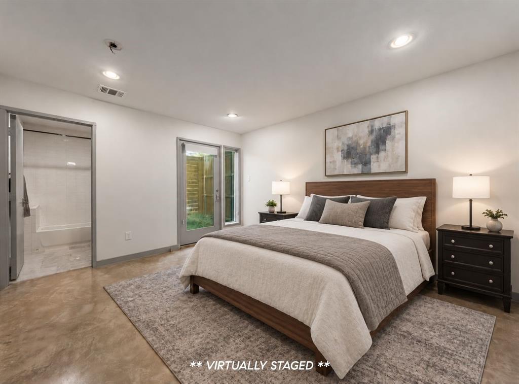 Polished concrete flooring, recessed lighting, and a glass-paneled exterior door