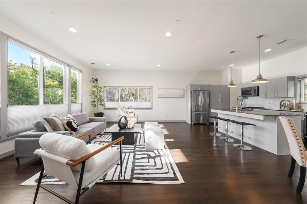 Open-concept interior featuring wood-finish flooring, recessed lighting, and expansive windows